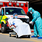 **

A diverse group of EMTs in full PPE (gloves, masks, eye protection, gowns) providing medical assistance to a patient at an accident scene. Focus on showcasing their professionalism and commitment to safety while working in a challenging environment. Include elements like an ambulance in the background and concerned family members observing.

**